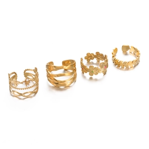 Detail of four gold adjustable rings with butterfly, wave, flower, and leaf designs