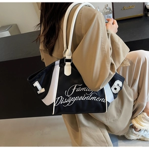 Fashion bowling handbag featuring black and white contrast mesh with 16 embroidery detail