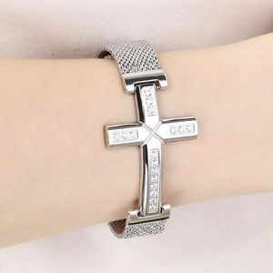 Detail of silver stainless steel cross bracelet with diamonds on Milanese mesh band