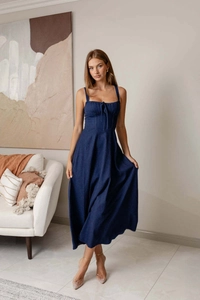 Detailed close-up of dark blue denim midi dress with square neck and drawstring bust detail