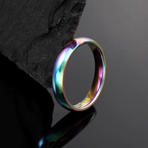 Minimalist 4mm rainbow gradient stainless steel ring on dark stone with mirror reflection