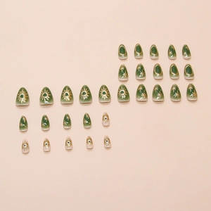 Faux ongles dégradés vert foncé avec motifs célestes dorés de soleil et d'étoiles