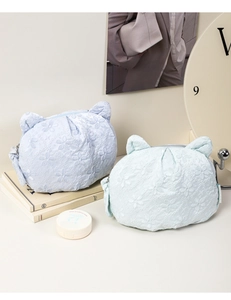 Detail of cute cat ear makeup bags with 3D floral embroidery in blue and mint green