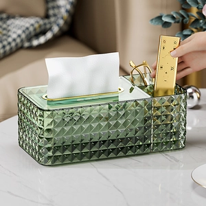 Detail of emerald green tissue box with diamond texture and gold metal accents
