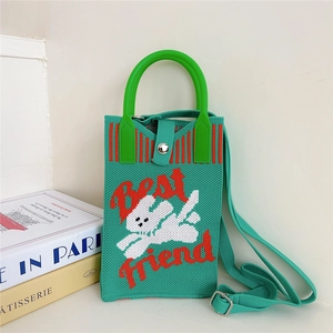 Detail of green knitted phone bag with white rabbit pattern and Best Friend text