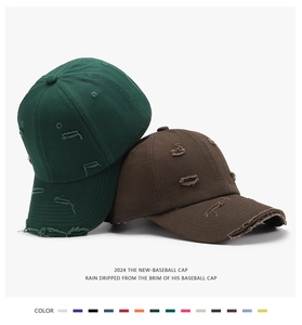 Detail of distressed ripped cotton baseball caps in dark green and brown vintage style