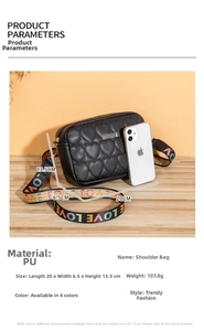 Detail of black heart-quilted PU leather camera bag with colorful LOVE ribbon strap