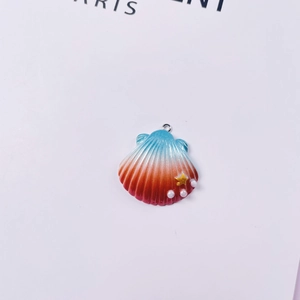 Detailed view of ocean shell pendant with blue to red gradient and pearl accents
