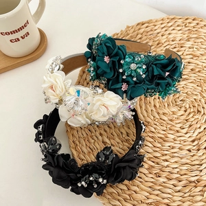 Detail of floral headbands with rhinestones and embroidery on a woven mat