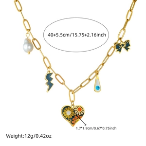 Gold titanium steel necklace with pearl heart and bow pendants on white background
