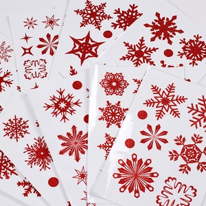 Close-up of red glitter snowflake and star static window stickers for Christmas decor