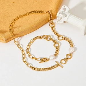 Luxurious gold stainless steel jewelry set with pearls and toggle clasp on white background