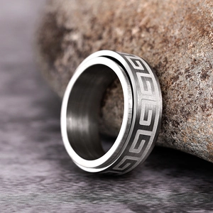 Detail of male spinner ring with Greek Fret pattern and brushed matte steel texture