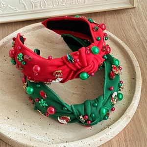 Detail of Christmas knot headbands with rhinestones and pearls on a stone tray