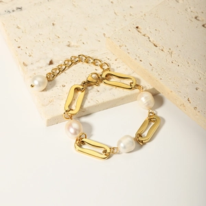 Detailed shot of gold plated titanium steel bracelet with natural freshwater pearls