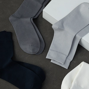 Men's premium cotton business socks in assorted neutral colors with fine knit texture