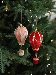 Detailed view of velvet hot air balloon Christmas ornaments with gold frame and pearls