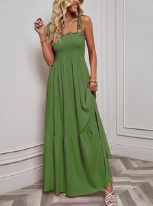 Detail of the green tiered maxi dress featuring a smocked bodice and delicate tie straps