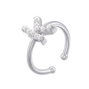 Detailed macro shot of silver ear clip with letter K shape and inlaid small pearls