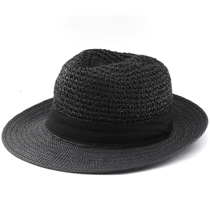 Close-up of black woven fedora straw hat with elegant satin band and textured finish