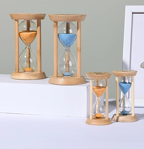 Detail view of four bamboo sand timers with blue and yellow sand in different sizes