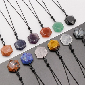 Detailed flat lay of hexagonal crystal pendants with natural stone textures and woven cords