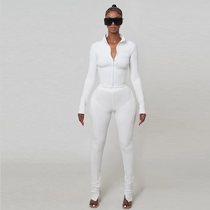 Close-up of white ribbed fabric texture on the long-sleeve zipper jacket and yoga pants