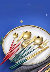 Close-up of Portuguese style 304 stainless steel cutlery set with gold finish and green handles