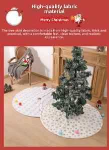 Detail of white plush Christmas tree skirt featuring embroidered and gold foil snowflakes