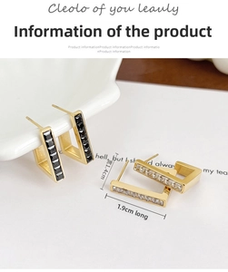 Detail view of rectangular gold-plated earrings with black and clear zircon stones