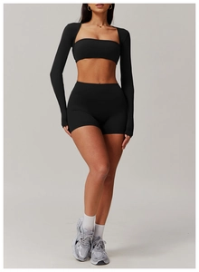 Close-up of three-piece black yoga set featuring sports bra, shorts, and zip-up jacket