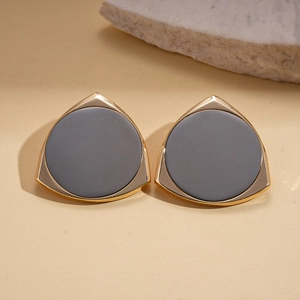 Detail of 14K gold plated geometric triangle earrings with dark grey matte inlay