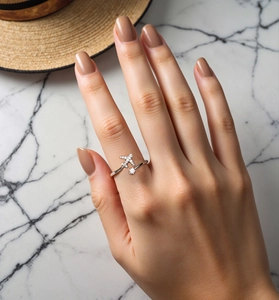Close-up of S925 sterling silver airplane ring with pavé crystals on marble background