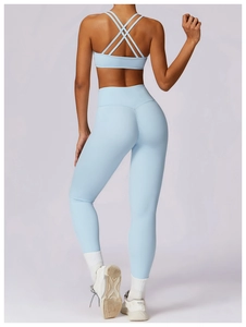Back view of light blue yoga set featuring cross-strap sports bra and high-waisted leggings