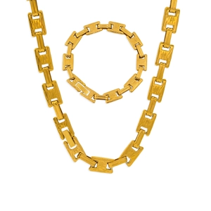 Macro detail of golden Triomphe link chain necklace and bracelet set in vintage style