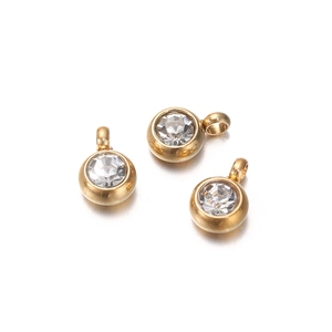 Detail showing three gold stainless steel round charms with inlaid clear zircon gemstones