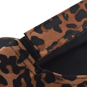 Close-up of suede leopard print fabric texture and black Velcro closure detail