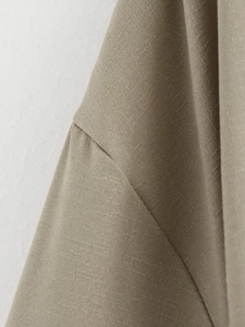 Detailed close-up of the shoulder seam and breathable linen-cotton fabric in khaki