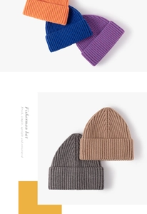 Detailed knit texture of ribbed fisherman beanies in orange, blue, and khaki colors