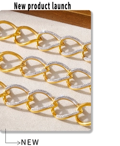 Macro detail of chunky gold-plated chain link bracelet with sparkling pave crystals
