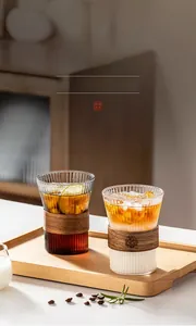 Detailed view of vertical striped glass cups with insulated wooden rings for iced coffee