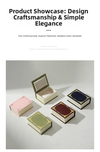 Macro detail of book-shaped jewelry boxes with gold vine patterns and soft lining
