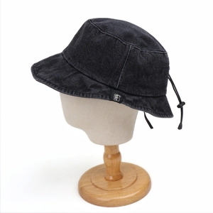 Detail view of washed denim bucket hat with adjustable drawstring and small H logo label
