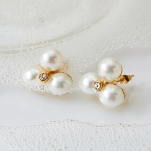Elegant three-pearl earrings with central diamond accent on gold base for women