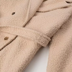 Beige wool coat with metal buttons and belted waist in textured boucle fabric