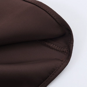 Detailed close-up showing coffee brown satin fabric texture and precise stitching detail