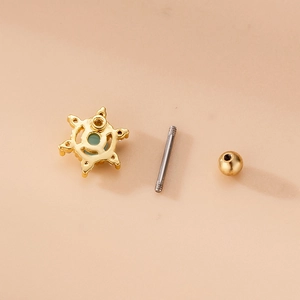 Star-shaped gold cartilage earring with green zircon and threaded screw back fastener