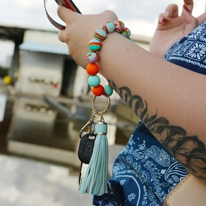 Macro view of silicone beaded keychain bracelet with leather tassel and car key