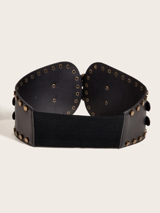 Detail of vintage black corset belt with metal buckles and textured faux leather