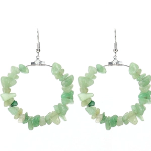 Detailed macro view of natural green gravel stones on a silver round hoop earring